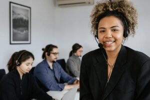 photo of a woman with curly hair wearing a black headset